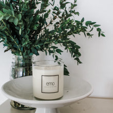 Load image into Gallery viewer, emo candle on tray in front of fresh eucalyptus